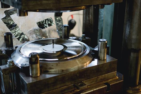 Vinyl manufacturing in progress with Vinyl in press machine